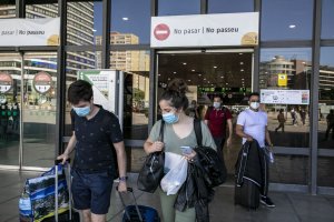 Travellers with face masks at Sants station