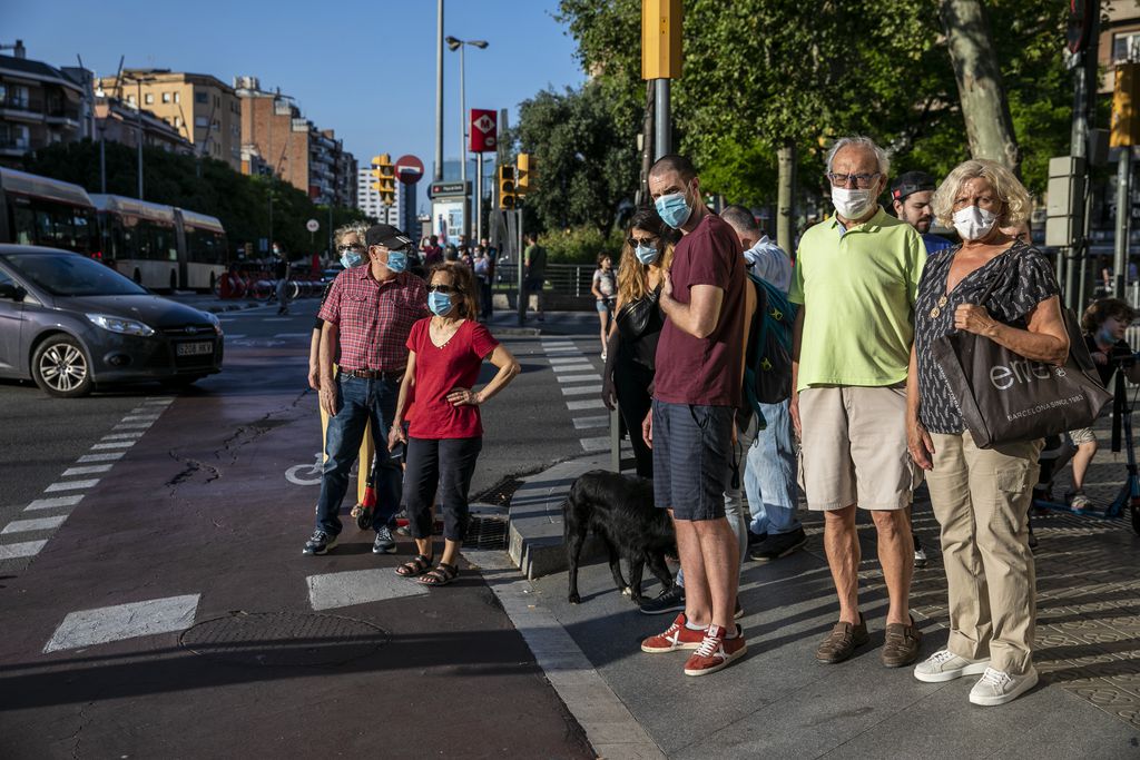 People waiting to cross a street in Barcelona