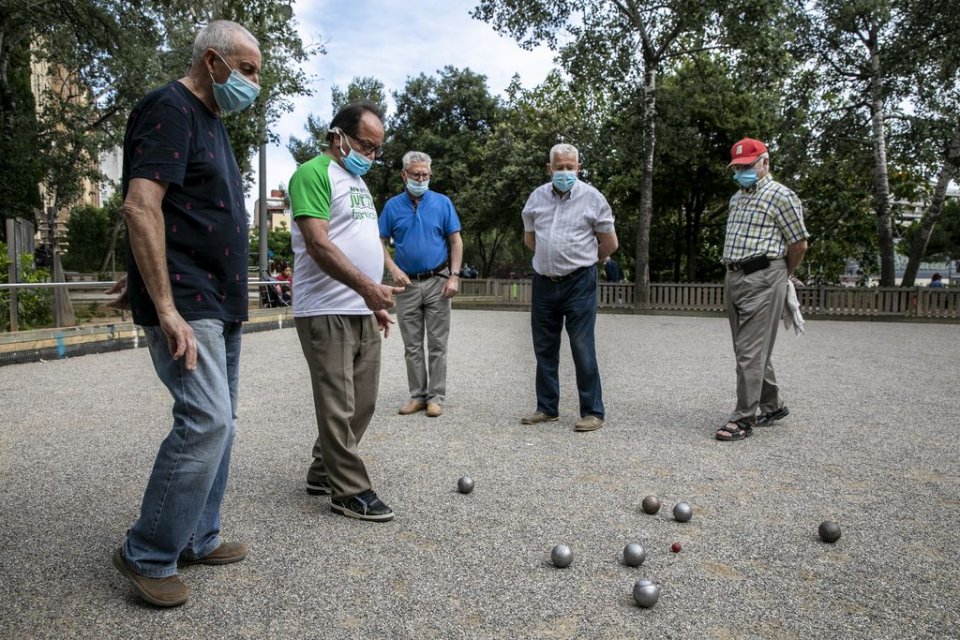 A group of men playing pétanque