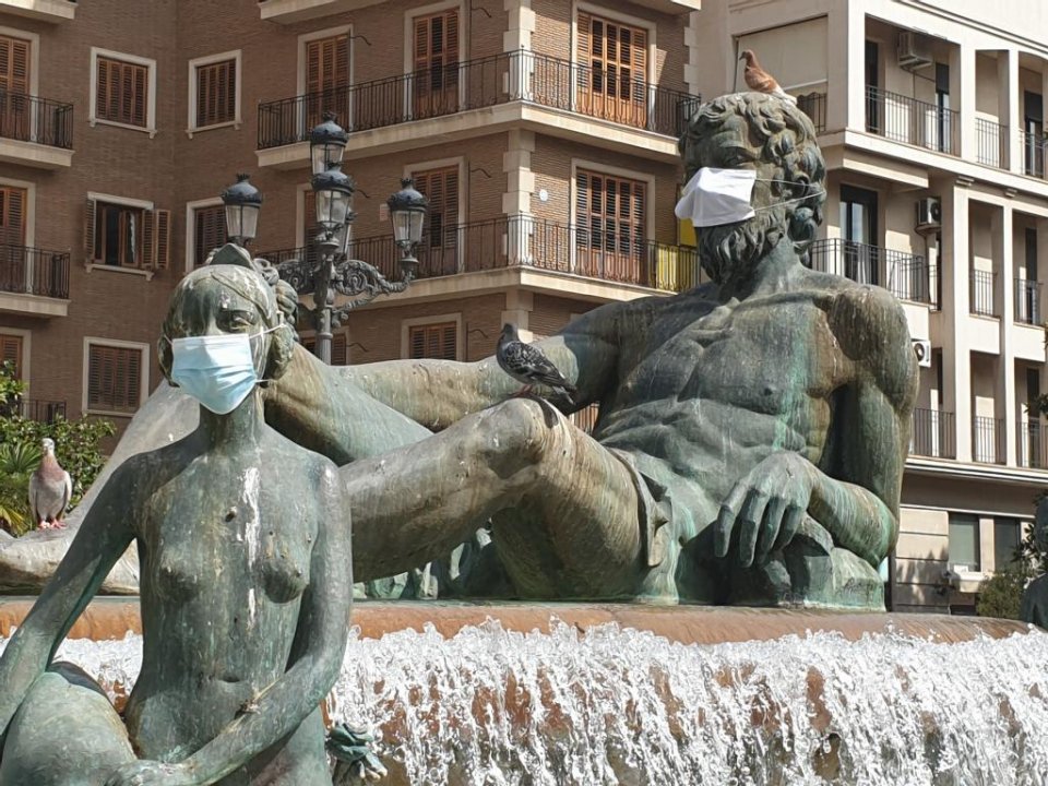 Face masks on statues in Valencia.