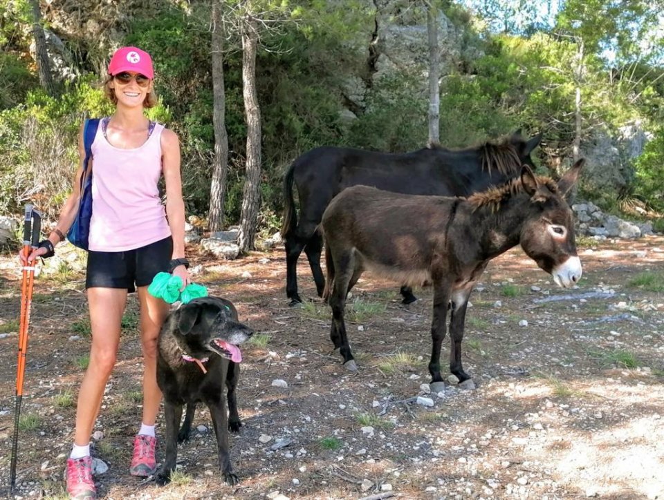 Marion Kuba, with her dog and two donkeys