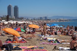 People sunbathing on Barceloneta beach in Barcelona in 2019