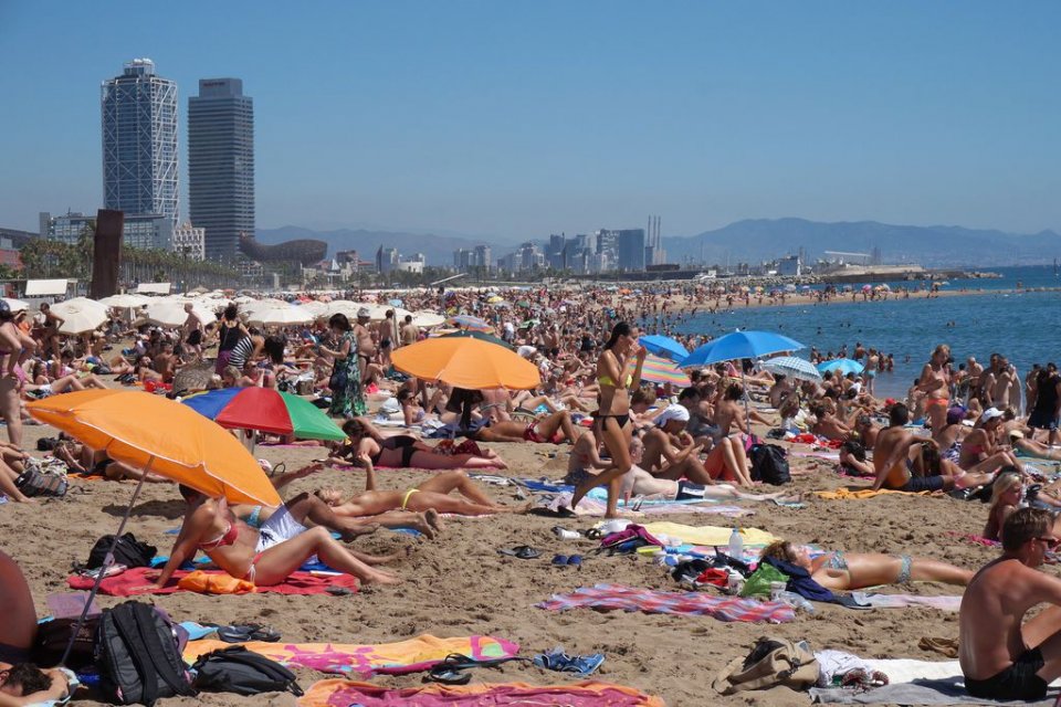 People sunbathing on Barceloneta beach in Barcelona in 2019