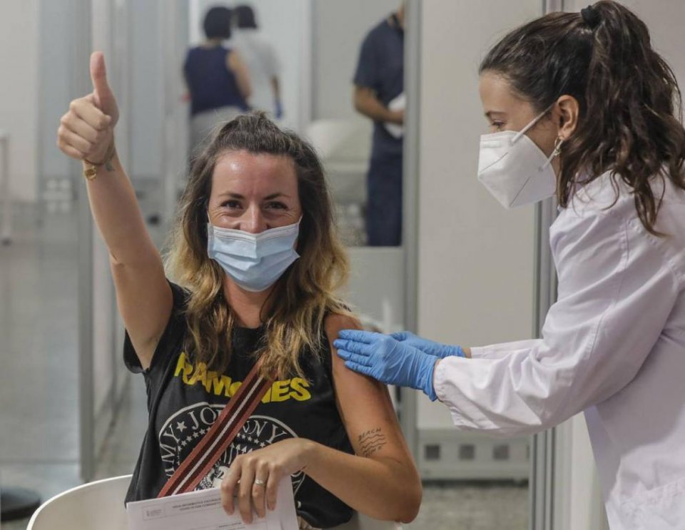 A woman giving the thumb up after receiving a vaccination in Valencia.