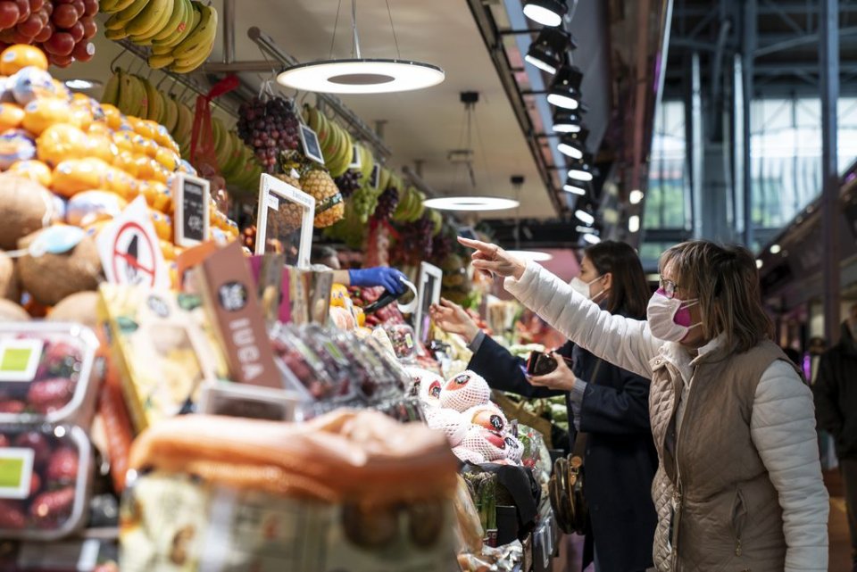 A woman buying food at a market in Barcelona