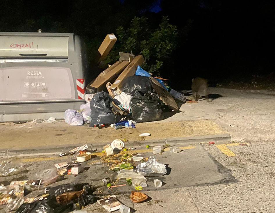 Garbage remains alongside a rubbish container in Quint Mar, Sitges, after a visit by wild boar.