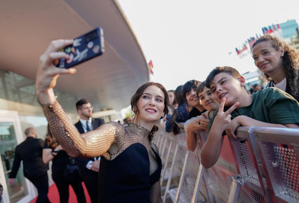 Ayuso takes a selfie on her way in to the Premios Platino film awards.